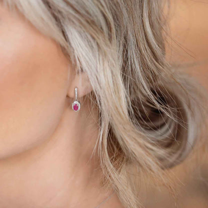 Genuine Oval Ruby Fashion Earrings with 1/10 ct. tw. Diamond Halo & Bail with Milgrain Edging in 10K White close-up detail