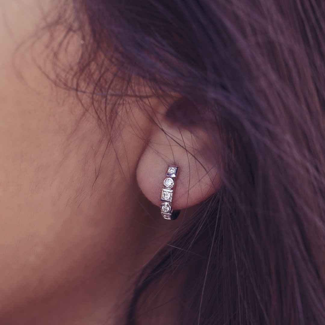 1/5 ct. tw. Round Diamond Fashion Huggie Hoop Earrings with Alternating Square & Circle Halos in 10K White Gold front view