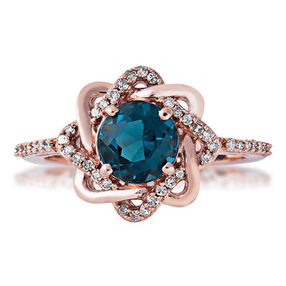 Impulse Collection 1/5 ct. tw. Diamond Twist Halo & Genuine London Blue Topaz Ring in 10K Pink Gold front view