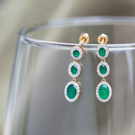 Oval Emerald and 1/3 ct. tw. Diamond Halo 3-Stone Drop Earrings in 14K Yellow Gold front view