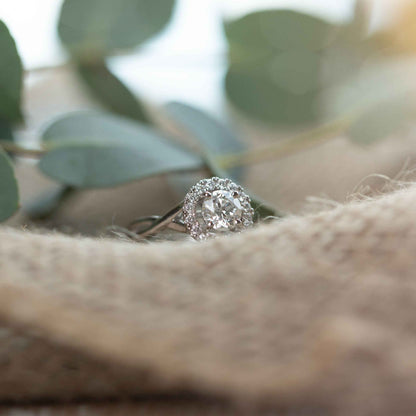 Natural 1-1/3 ct. tw. Round Brilliant Diamond Halo Twist Engagement Ring in 14K White Gold close-up detail