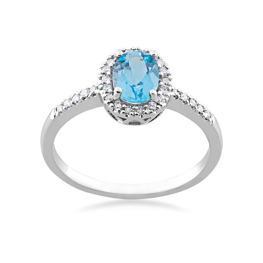 Genuine Oval Blue Topaz & 1/7 ct. tw. Diamond Halo Fashion Ring in 10K White Gold