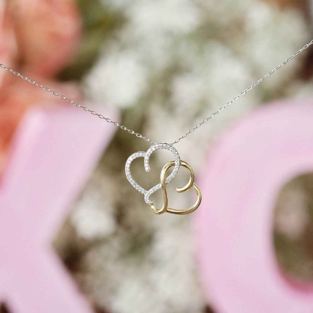 Infinite Love 1/5 ct. tw. Diamond Triple Heart Infinity Pendant in Sterling Silver & 10K Yellow Gold close-up detail