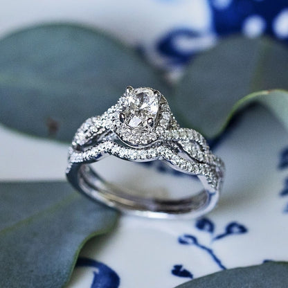 Natural 1 ct. tw. Oval Diamond Halo Twist Wedding Set in 14K White Gold angled view