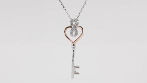 Infinite Love 1/6 ct. tw. Diamond Heart Key Pendant in Sterling Silver and 10K Pink Gold close-up detail