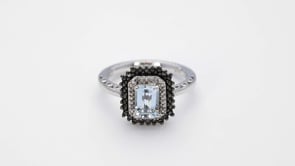 Created Emerald Cut Aquamarine and Treated Black Diamond Halo Ring In Sterling Silver close-up detail
