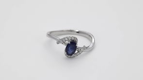Oval Sapphire and 1/10 ct. tw. Diamond Bypass Ring in 10K White Gold close-up detail