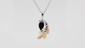 Black Hills Gold Pear Onyx & Leaf Branch Pendant in Sterling Silver close-up detail