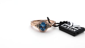 Le Vian Chocolatier Oval Deep Sea Blue Topaz & 1/5 ct. tw. Chocolate & Vanilla Diamond Halo Twist Ring in 14K front view