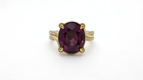 Oval Garnet & 1/4 ct. tw. Diamond Ring in 18K Yellow Gold close-up detail