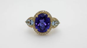 Oval Tanzanite, Pear Aquamarine, & 1/3 ct. tw. Diamond 3-Stone Ring in 18K Yellow Gold close-up detail