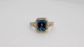 Emerald Cut London Blue Topaz & 1/3 ct. tw. Diamond Halo Ring in 10K Yellow Gold close-up detail