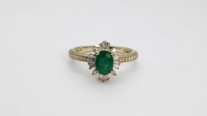 Oval Emerald and 1/4 ct. tw. Diamond Starburst Halo Ring in 10K Yellow Gold side profile