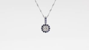 1/6 ct. tw. Round Diamond Yogo Sapphire Halo Pendant in 10K White Gold front view
