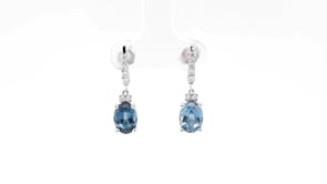 Oval London Blue Topaz & 1/5 ct. tw. Diamond Dangle Earrings in 10K White Gold front view