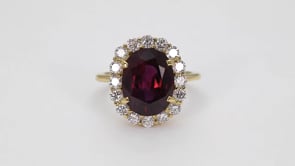 Oval Ruby & 7/8 ct. tw. Diamond Halo Ring in 18K Yellow Gold close-up detail