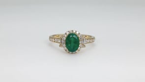 Oval Emerald & 1/2 ct. tw. Round & Baguette Diamond Halo Ring in 18K Yellow Gold side profile