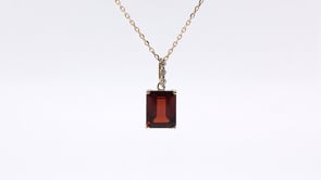 Emerald Cut Garnet & Diamond Accent Pendant in 10K Yellow Gold front view