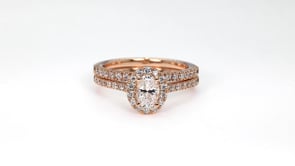 Natural 1 ct. tw. Oval Diamond Halo Wedding Set in 14K Pink Gold angled view