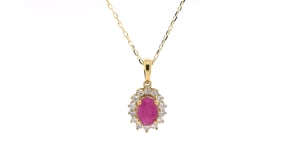 Oval Ruby & 1/4 ct. tw. Diamond Halo Pendant in 10K Yellow Gold front view