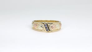 Black Hills Gold Men's Round 3-Stone Yogo Sapphire Channel Set Wedding Ring in 10K Yellow Gold close-up detail