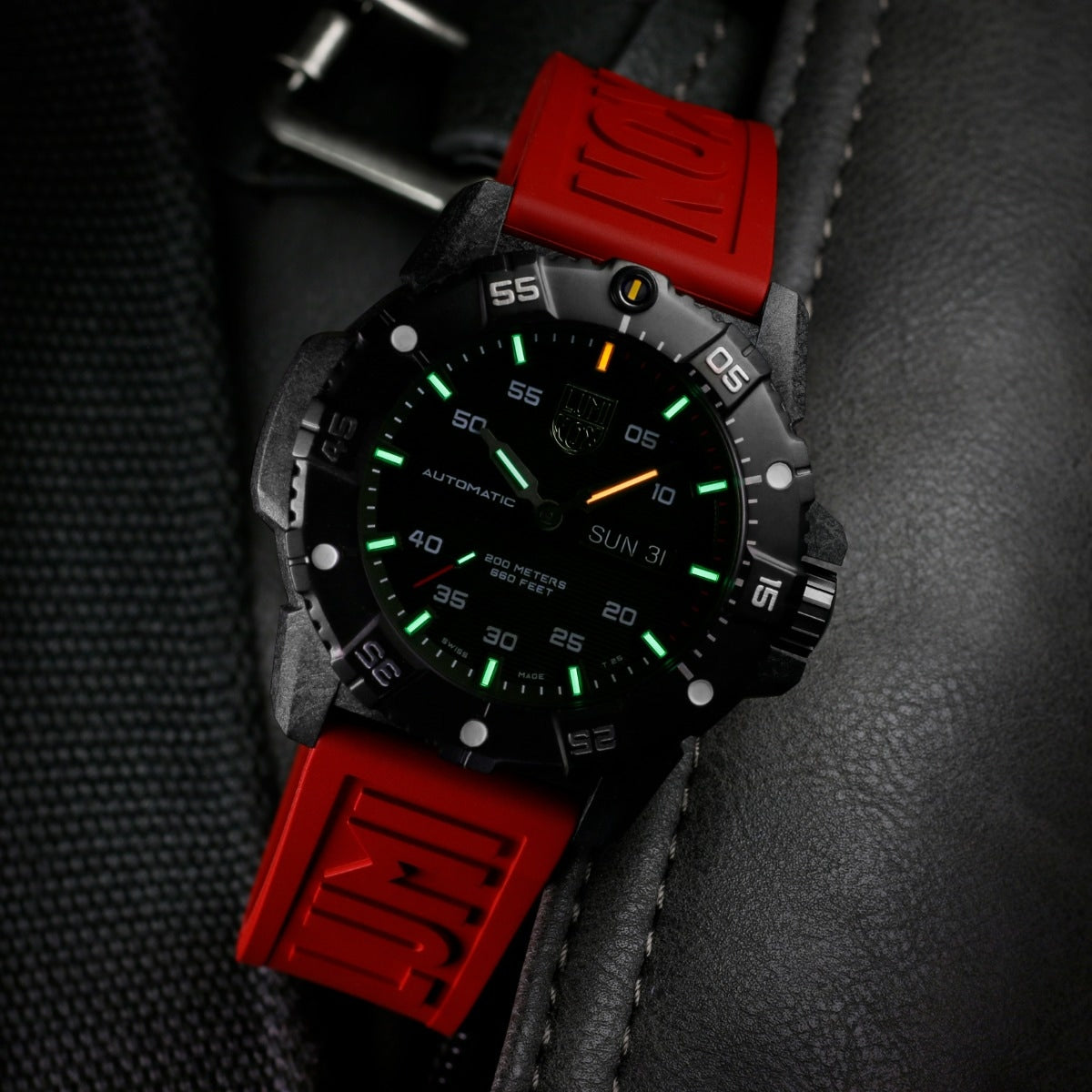 Luminox Men's Master Carbon SEAL Automatic Carbonox+ Watch with Black Dial & Red Rubber Strap close-up detail