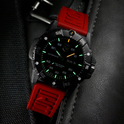 Luminox Men's Master Carbon SEAL Automatic Carbonox+ Watch with Black Dial & Red Rubber Strap close-up detail