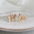 Pink and green gold leaf butterfly stud earrings in yellow gold beauty shot
