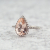 pear morganite ring with diamond halo set in white gold beauty shot
