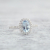 white gold oval aquamarine ring with diamond halo beauty shot