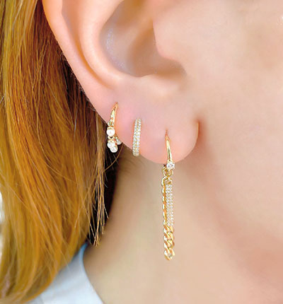 diamond and gold earrings on model